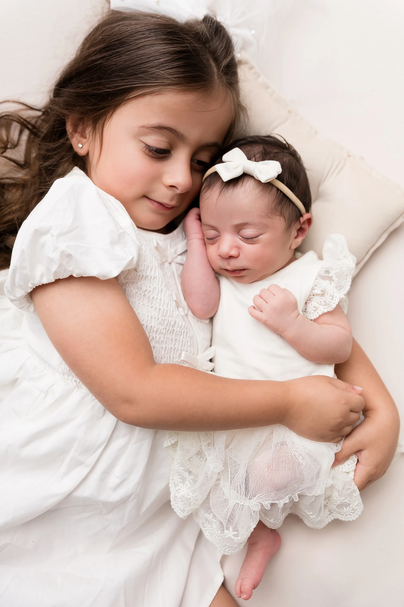 Newborn cradled in cream