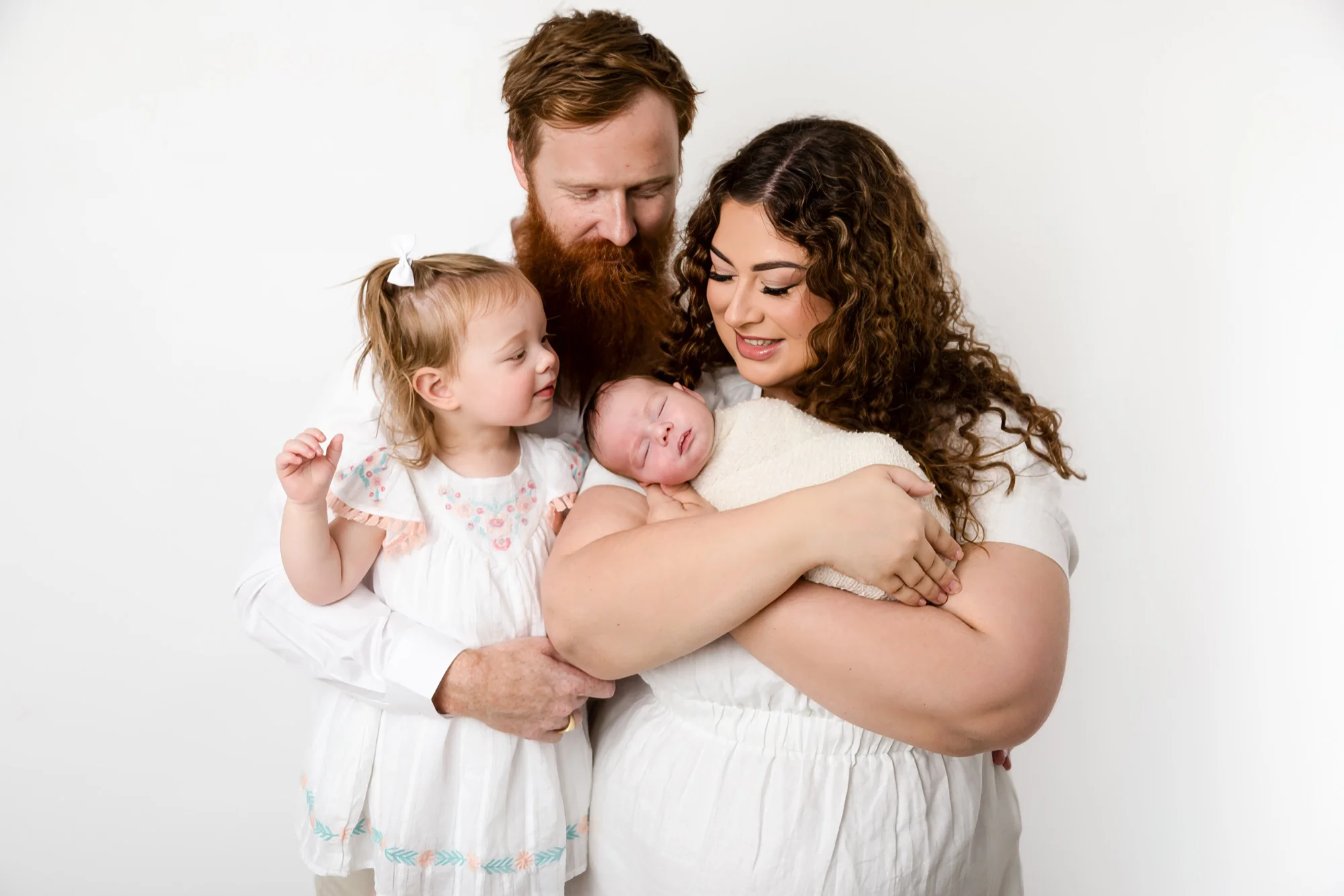 Family with their newborn in the Glen Alpine studio